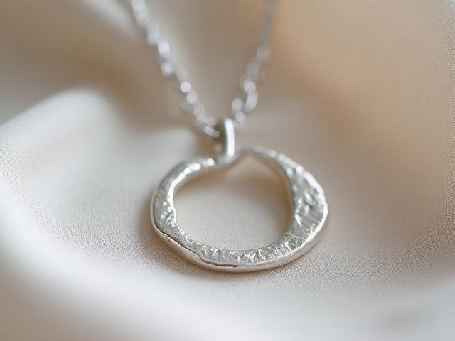 Sterling silver crescent moon pendant with intricate detailing