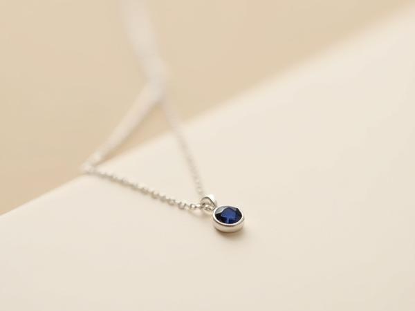 Sterling silver necklace with a tiny faceted birthstone pendant