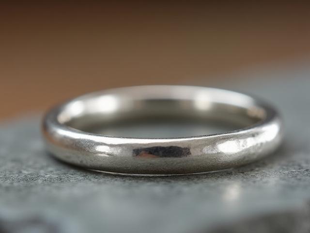 A sterling silver ring with a subtle hammered texture, suitable for stacking.